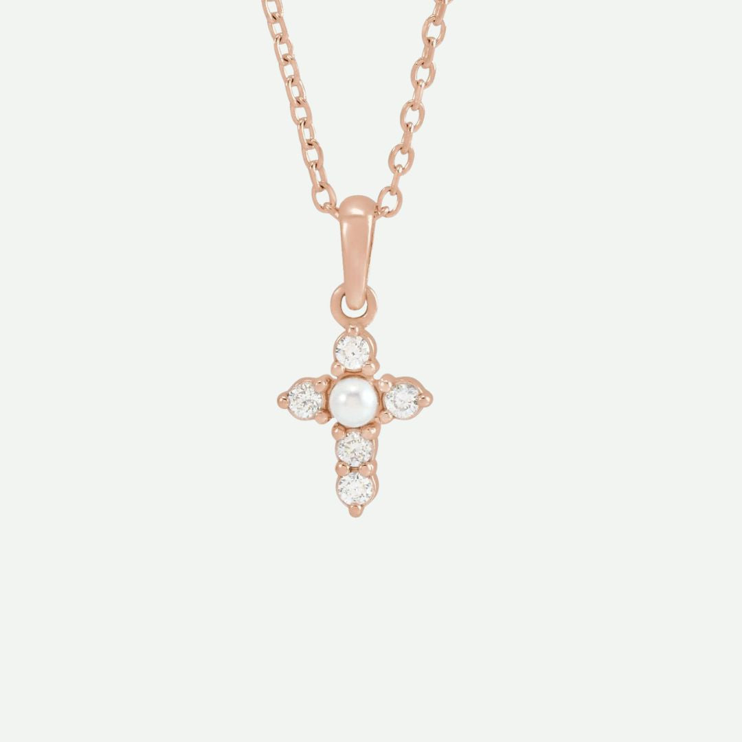 Front view of the GRACED necklace in rose gold, showcasing a pearl and diamonds on the cross, blending warmth with devotion.
