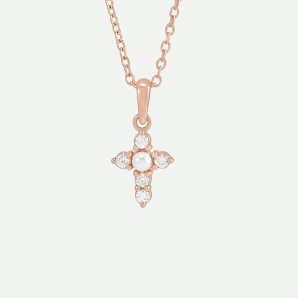 Front view of the GRACED necklace in rose gold, showcasing a pearl and diamonds on the cross, blending warmth with devotion.
