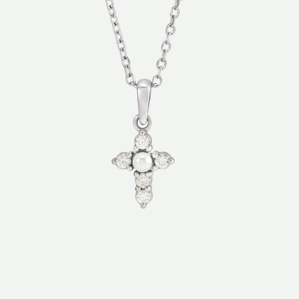 Front view of the GRACED necklace in sterling silver, featuring a seed pearl and diamonds on the cross as a symbol of grace and faith.