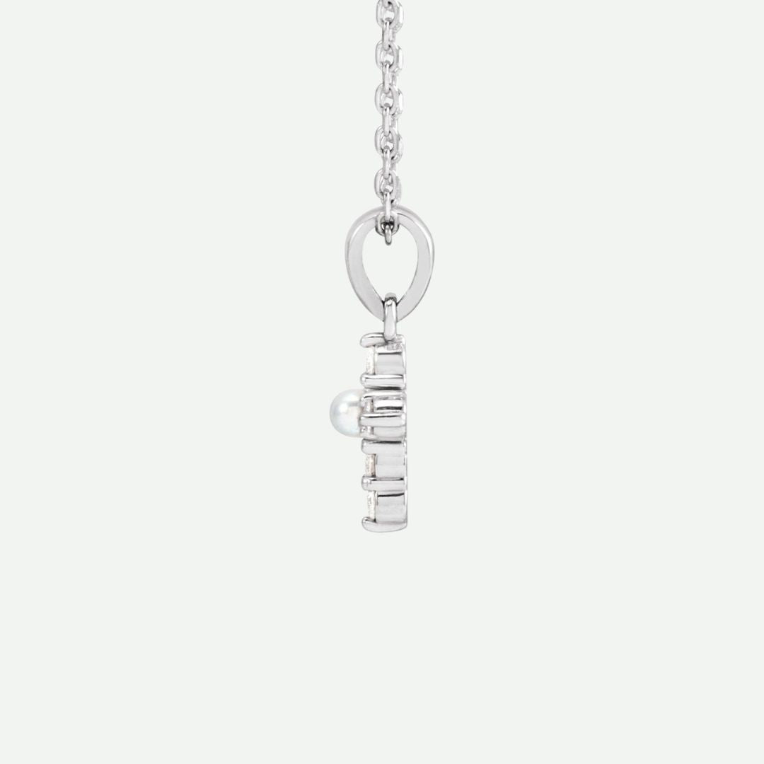 Side view of the GRACED sterling silver pearl and diamond cross necklace, highlighting its delicate design and devotion-filled meaning.