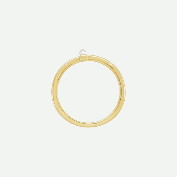 Top view of the PRECIOUS sideways cross ring in yellow gold with a centered white Akoya pearl, symbolizing purity and treasured faith.