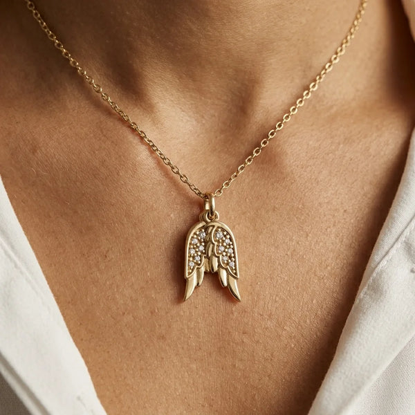 Woman wearing Glor-e’s yellow-gold Angel Wings Christian necklace as an elegant everyday expression of faith