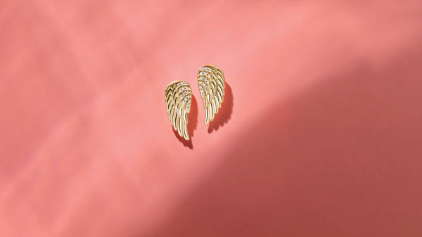 A pair of Angel Wings Christian Earrings on a studio background | Glor-e