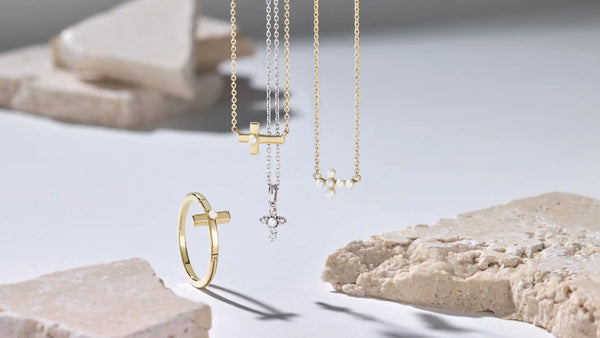 Gold Christian jewelry including necklaces and a ring – styled on a neutral background for Glor-e