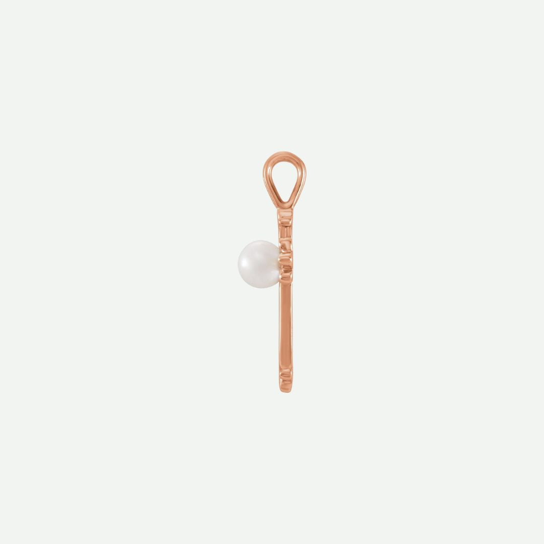 Side view of the RADIANCE rose gold pearl cross pendant, emphasizing its soft glow and modern Christian style.