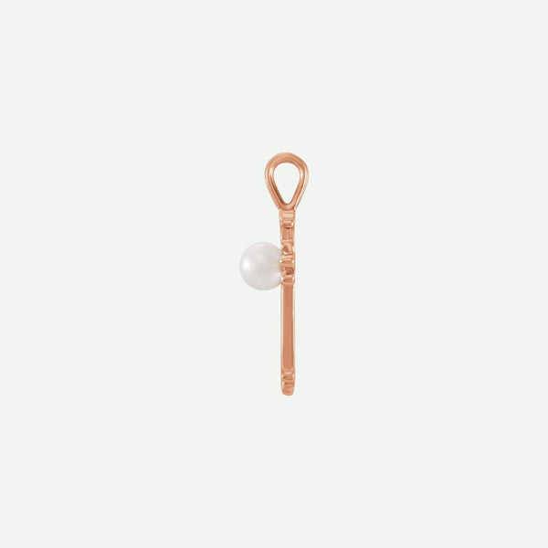 Side view of the RADIANCE rose gold pearl cross pendant, emphasizing its soft glow and modern Christian style.