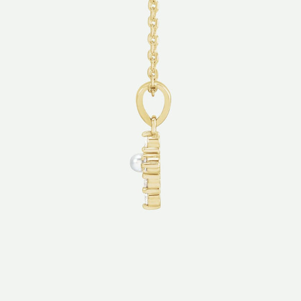 Side view of the GRACED yellow gold pearl and diamond cross necklace, highlighting its refined details and timeless Christian elegance.