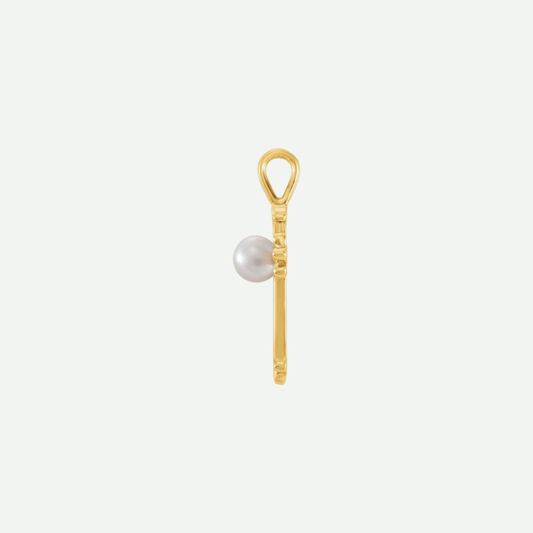 Side view of the RADIANCE yellow gold pearl cross pendant, highlighting its depth and refined craftsmanship.