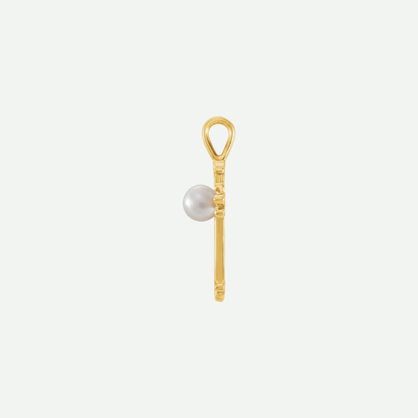 Side view of the RADIANCE yellow gold pearl cross pendant, highlighting its depth and refined craftsmanship.