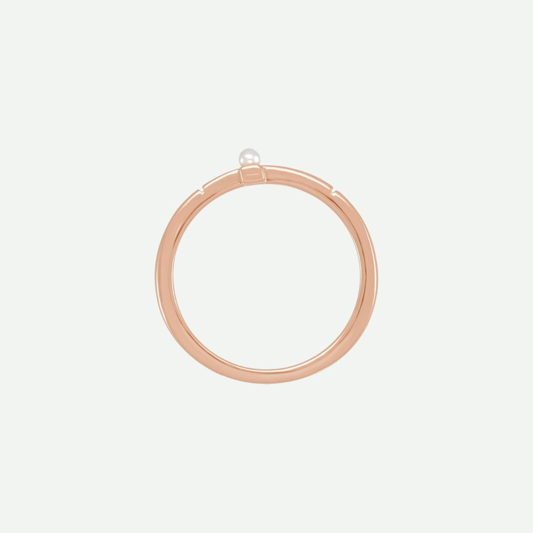 Top view of the PRECIOUS sideways cross ring in rose gold with a white Akoya pearl, a graceful reminder of faith’s priceless beauty.