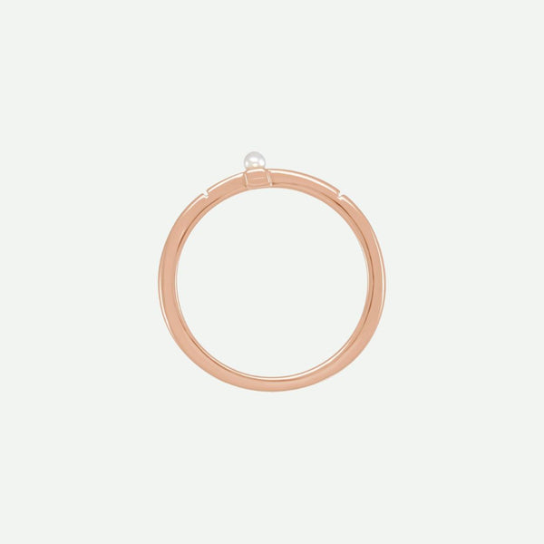 Top view of the PRECIOUS sideways cross ring in rose gold with a white Akoya pearl, a graceful reminder of faith’s priceless beauty.