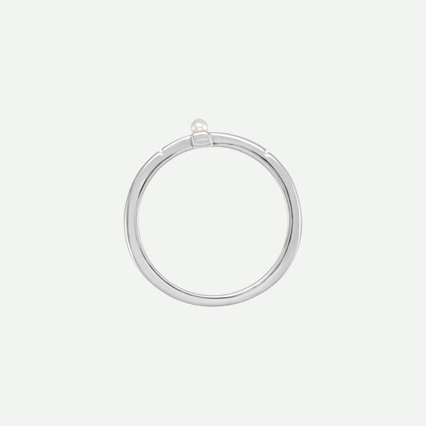 Top view of the PRECIOUS sideways cross ring in sterling silver, accented by a white Akoya pearl as a symbol of purity and faith.