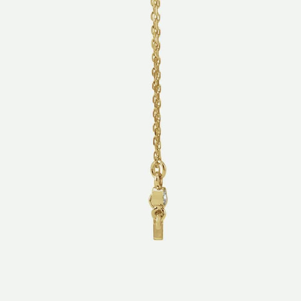 Side view of yellow gold Sideways Cross Christian necklace for women